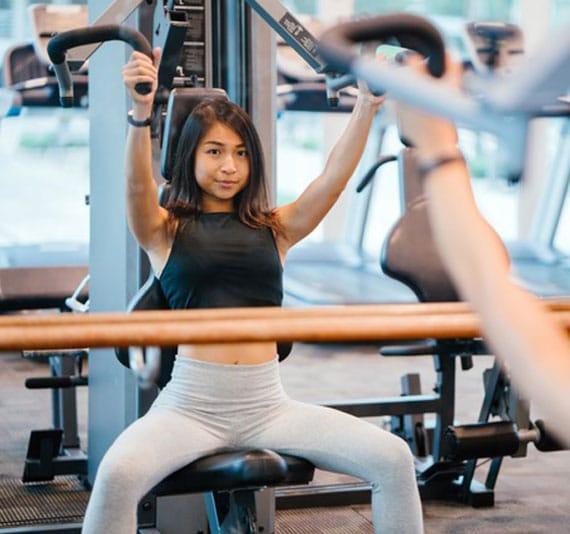 Woman using gym equipment